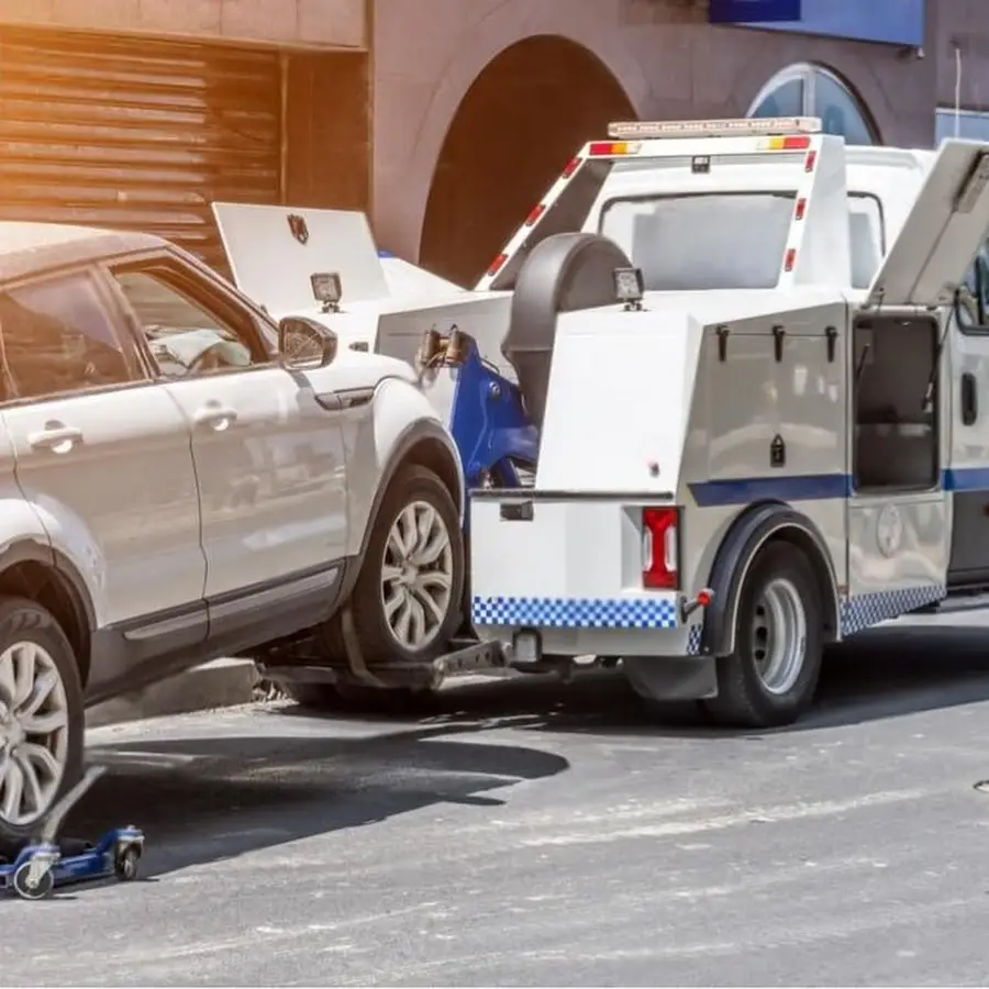 Calgary tow truck loading vehicles for professional towing and roadside assistance service