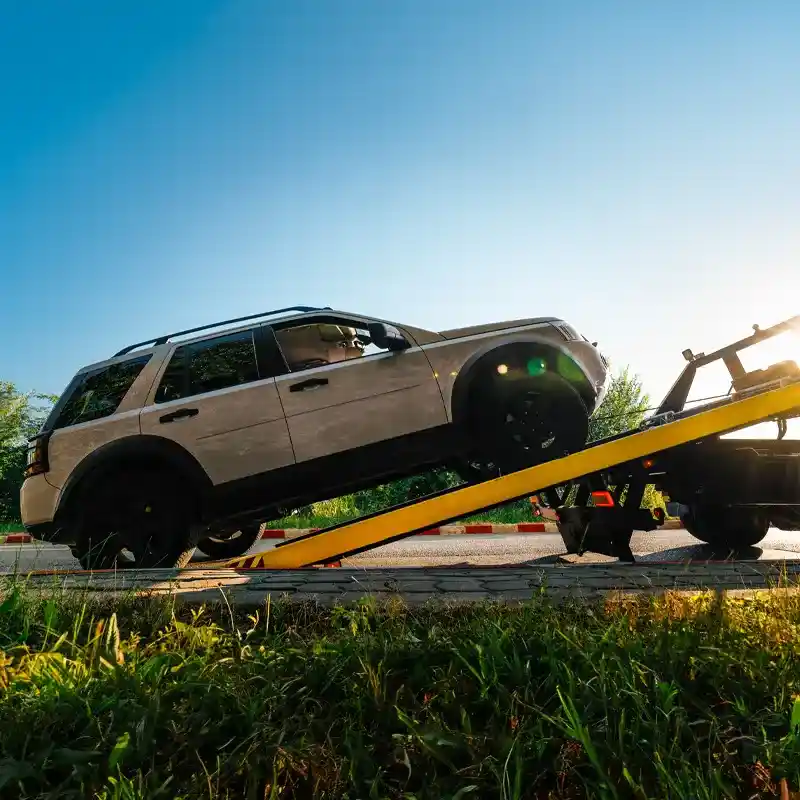 SUV loaded on hydraulic ramp flatbed tow truck for safe Calgary transport.