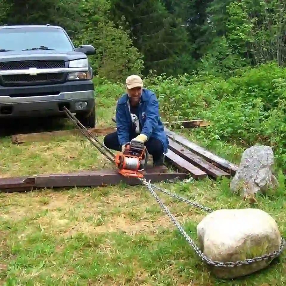 Tow Truck Calgary roadside winching service with safety warning triangle setup